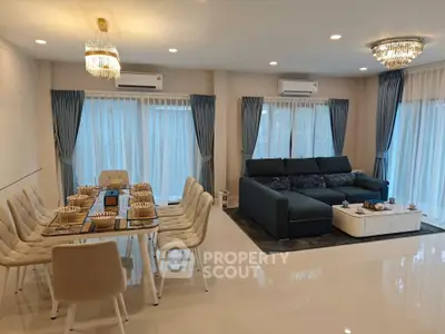 Luxurious living room with elegant dining area and modern furnishings, perfect for stylish entertaining.