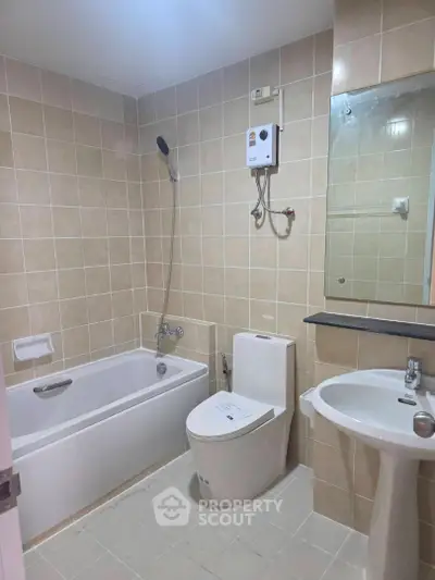 Modern bathroom with bathtub and sleek fixtures in a stylish apartment.