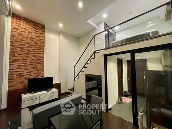 Modern loft-style living room with high ceiling and mezzanine bedroom