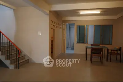 Spacious interior with modern design featuring a staircase and dining area, ideal for contemporary living.