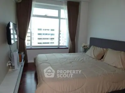 Cozy bedroom with large window and modern decor in urban apartment