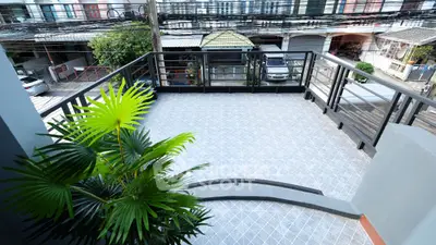 Spacious balcony with modern railing and street view, perfect for relaxation.
