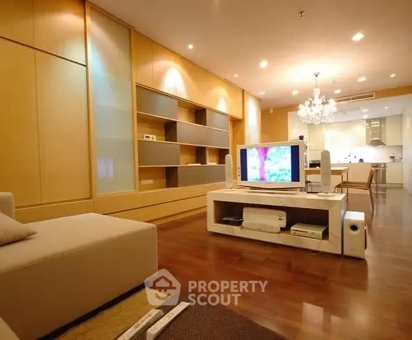 Spacious modern living room with open kitchen and elegant chandelier