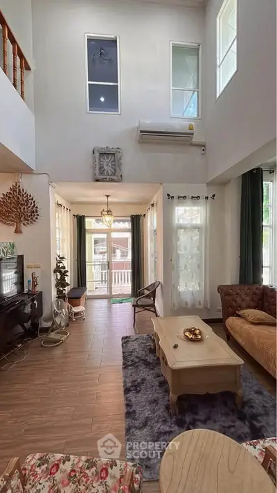 Spacious living room with high ceiling and elegant decor