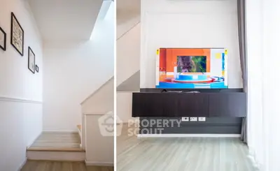 Modern interior with sleek TV setup and stylish staircase in a bright home.