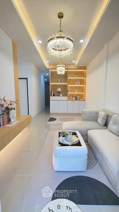 Luxurious modern living room with elegant chandeliers and plush sofa, perfect for stylish urban living.