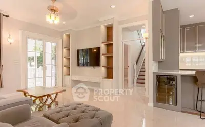 Elegant living room with modern decor, large windows, and stylish furniture in a bright, spacious home.