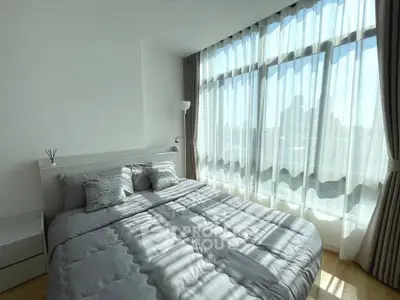 Bright modern bedroom with large windows and stylish decor