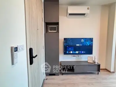 Modern living room with wall-mounted TV and air conditioning unit, showcasing sleek design and comfort.