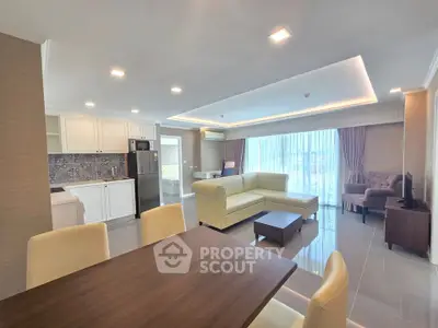 Spacious modern living room with open kitchen and elegant furnishings