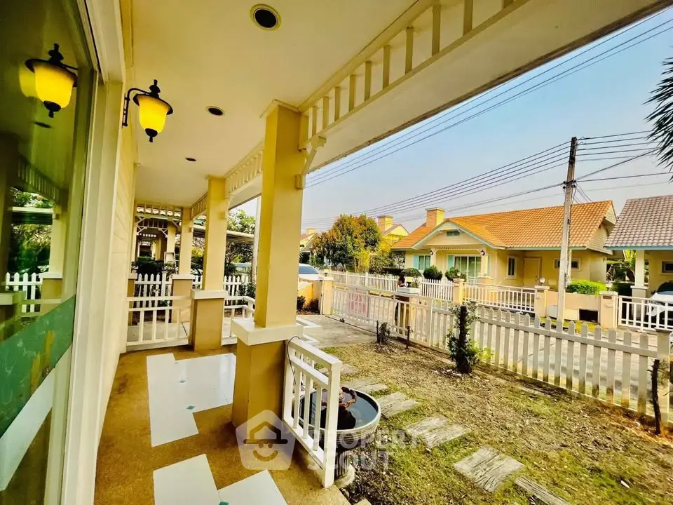 Charming suburban home with inviting front porch and garden view