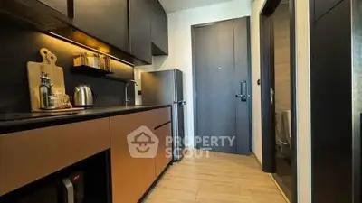 Modern kitchen with sleek cabinetry and stainless steel appliances in a compact layout.