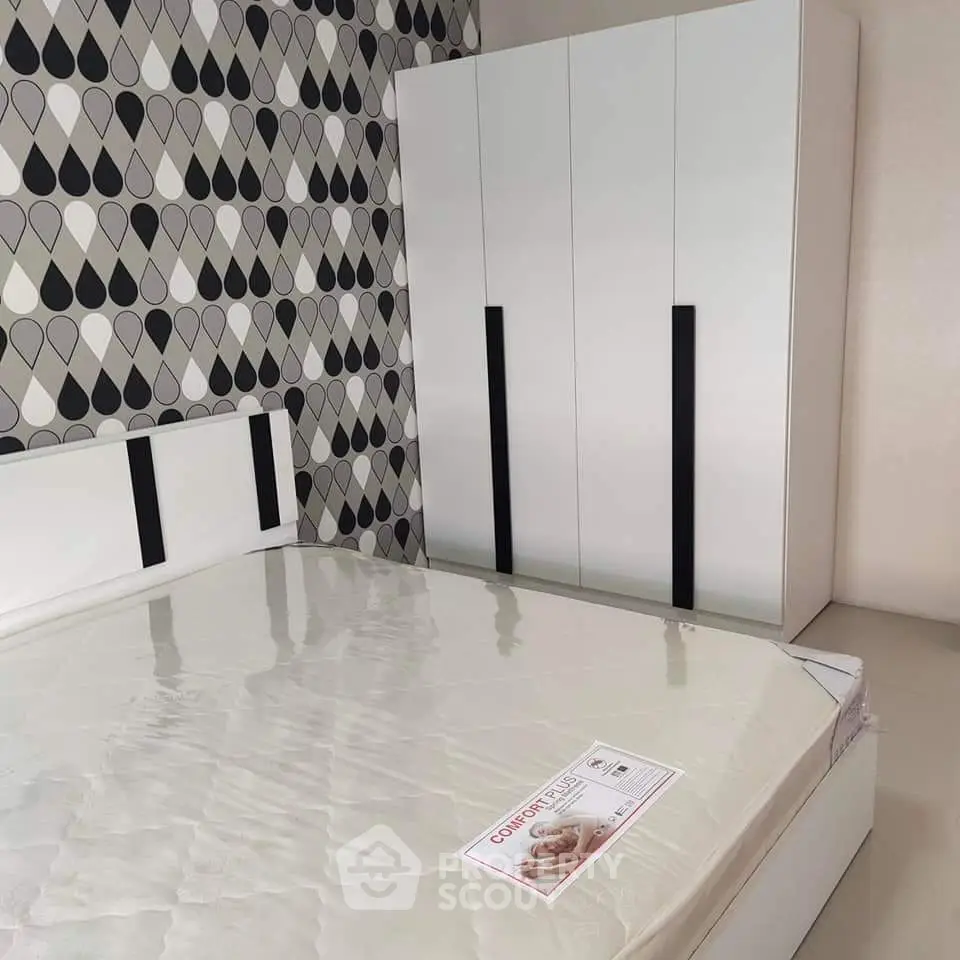 Modern bedroom with stylish wallpaper and sleek wardrobe design