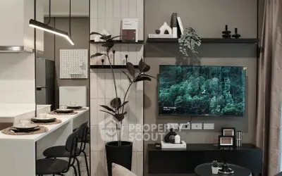 Modern living room with stylish decor and wall-mounted TV, open to a sleek kitchen area.