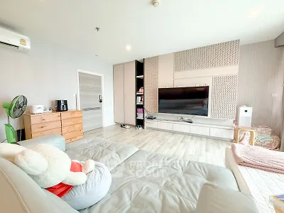 Spacious modern living room with stylish decor and large TV setup