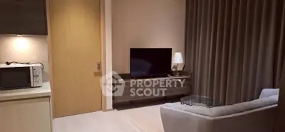 Modern living room with sleek TV stand, cozy sofa, and stylish decor