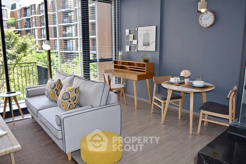 Modern living room with stylish furniture and balcony view in urban apartment