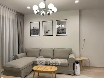 Modern living room with stylish sofa, elegant lighting, and minimalist decor for a cozy ambiance.