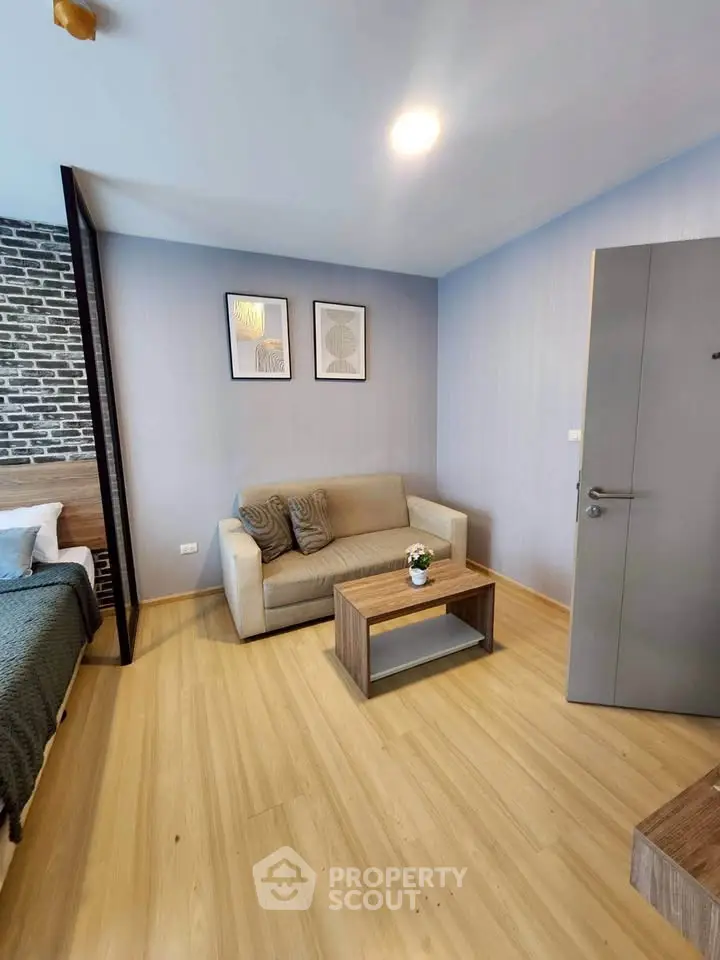 Modern living room with cozy sofa and stylish decor in a contemporary apartment.