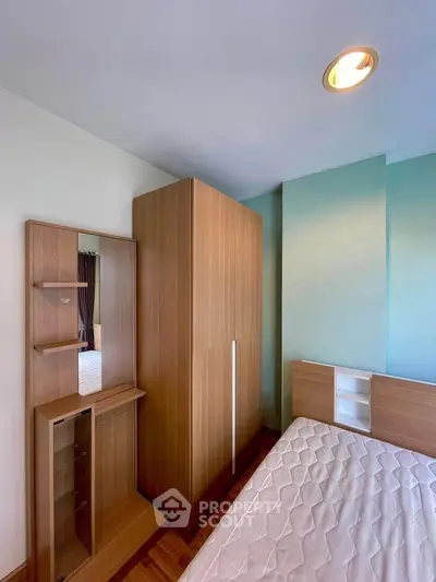 Modern bedroom with wooden wardrobe and bed in a cozy apartment