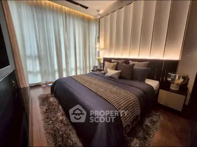 Luxurious bedroom with elegant decor and ambient lighting, featuring a plush bed and stylish furnishings.