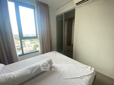 Modern bedroom with large window and built-in wardrobe offering a bright and airy atmosphere.