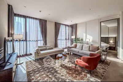 Luxurious modern living room with stylish furniture and large windows offering abundant natural light.