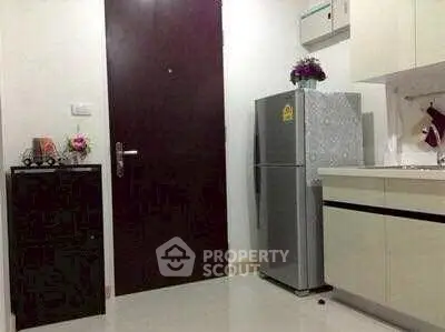 Compact kitchen with modern fridge and sleek cabinetry