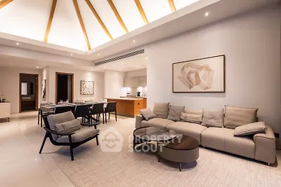 Luxurious modern living room with elegant furniture and open kitchen layout, perfect for entertaining.