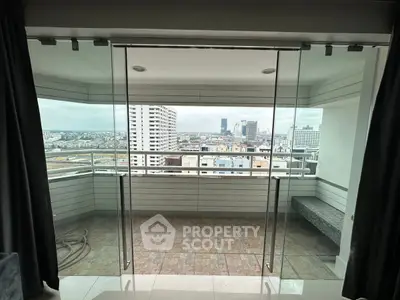 Spacious balcony with stunning city view and glass doors in modern apartment