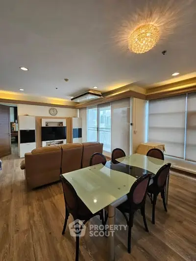 Spacious living room with elegant dining area and modern lighting