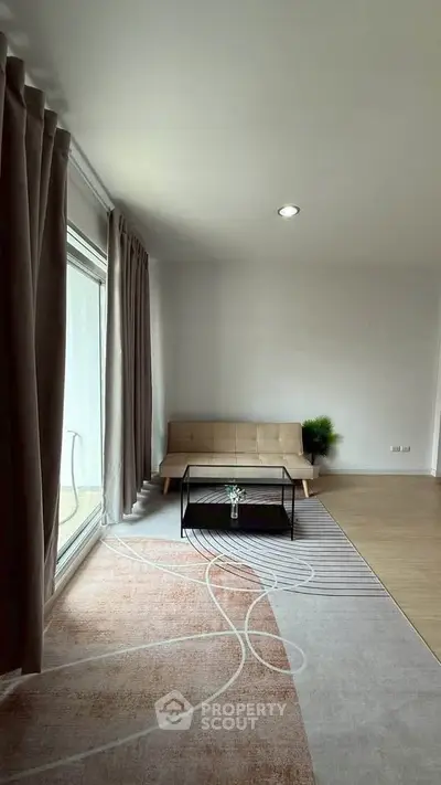Spacious living room with modern decor and large window