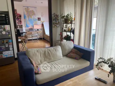 Cozy living room with modern decor and natural light, perfect for relaxation.