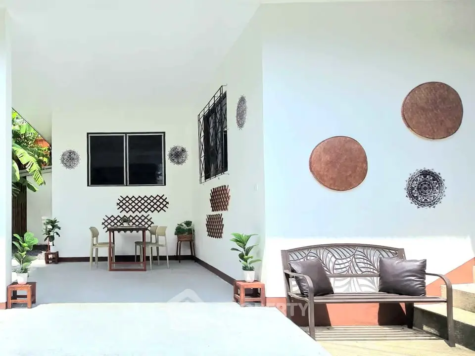 Charming outdoor seating area with stylish decor and lush greenery, perfect for relaxation and entertaining.