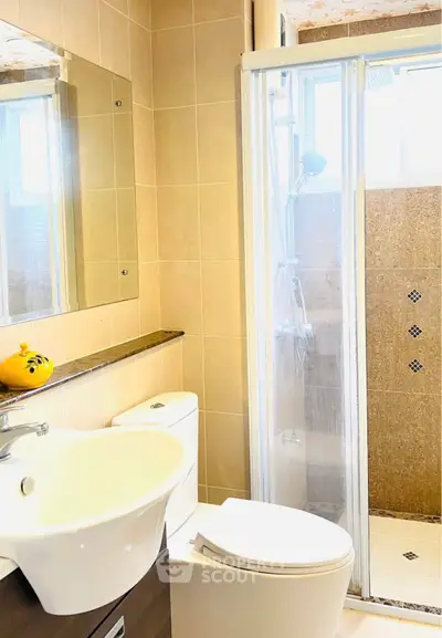 Modern bathroom with sleek fixtures and glass shower enclosure