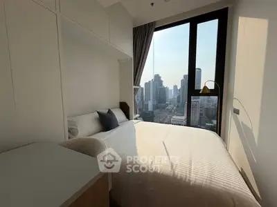 Modern bedroom with city view and natural light