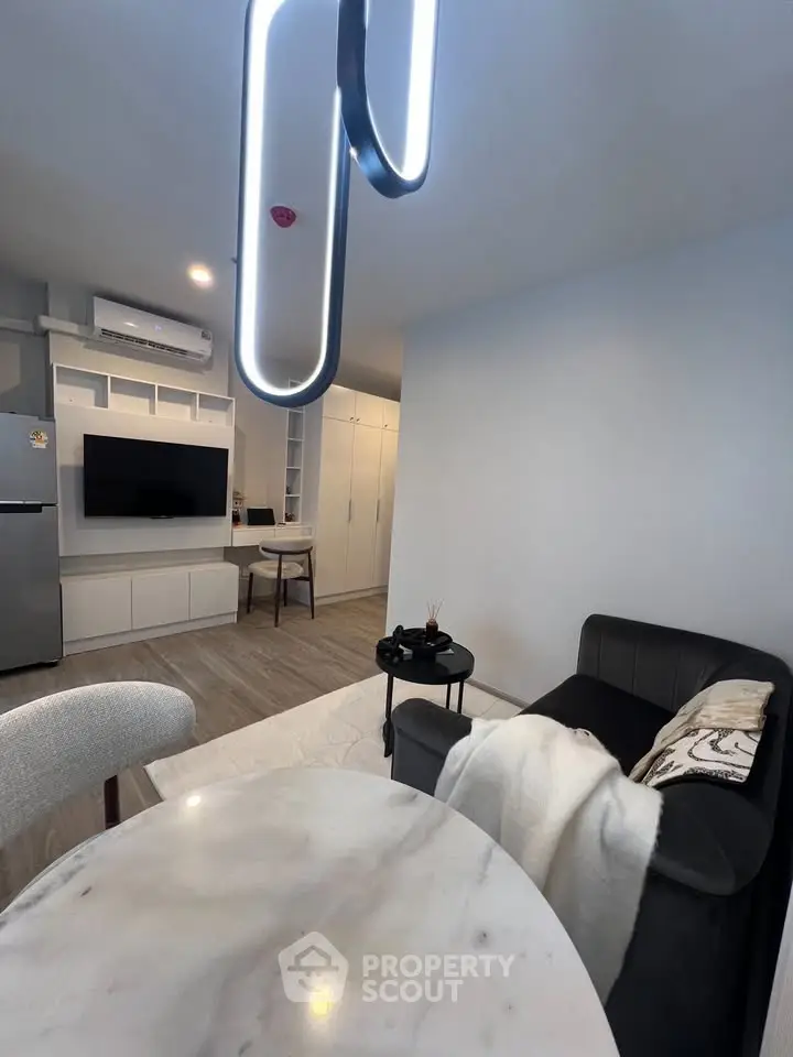 Modern living room with sleek furniture and stylish lighting in a contemporary apartment.