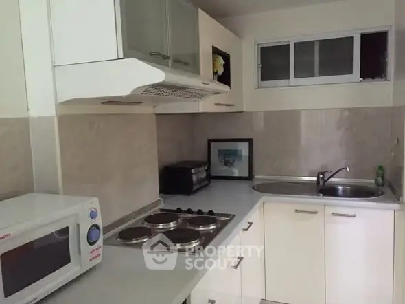 Compact kitchen with modern appliances and sleek cabinetry