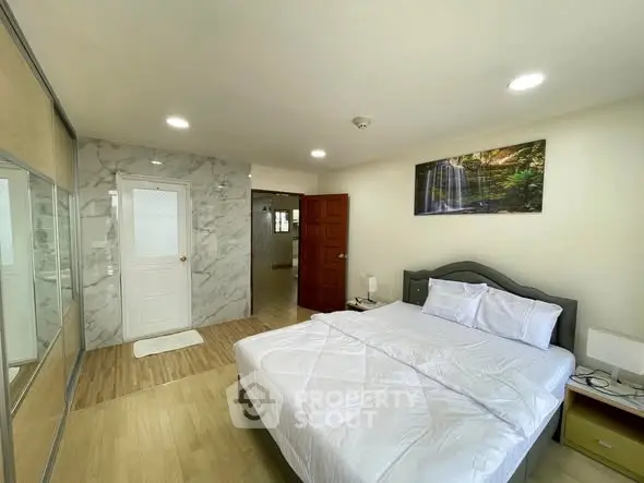 Spacious bedroom with modern decor and natural light