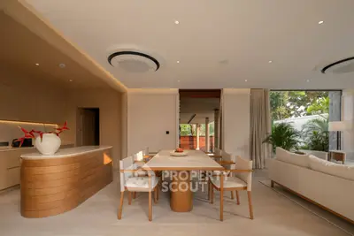 Luxurious open-plan living and dining area with modern decor and natural light.