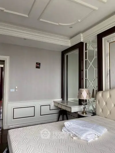 Luxurious bedroom with elegant decor and plush furnishings in a modern apartment.