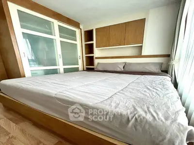 Cozy bedroom with modern built-in wardrobe and natural light