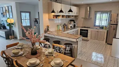 Modern open-plan kitchen and dining area with stylish decor and natural light