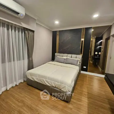 Modern bedroom with elegant decor and wooden flooring