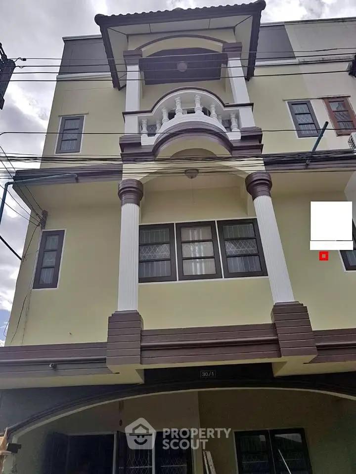 Elegant multi-story building with classic architectural details and large windows.