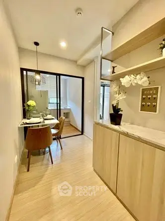 Modern dining area with elegant decor and wooden flooring in a cozy apartment.
