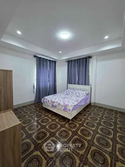 Spacious bedroom with elegant flooring and cozy bed setup