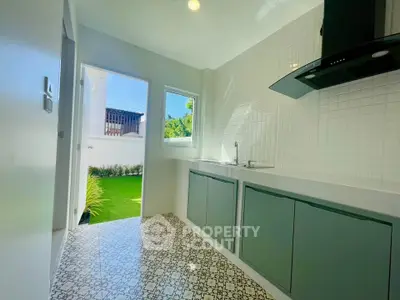 Bright modern kitchen with open layout and garden view