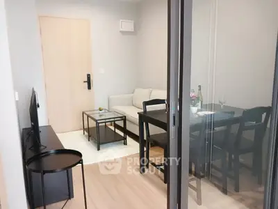 Modern living room with sleek furniture and glass door, perfect for cozy gatherings.