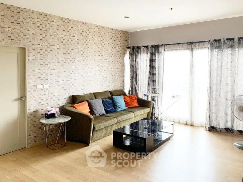 Spacious living room with modern decor and large windows for natural light.